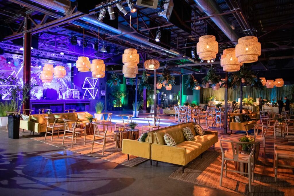 The Midway venue in San Francisco with yellow couches, multiple lounges, and warm lighting
