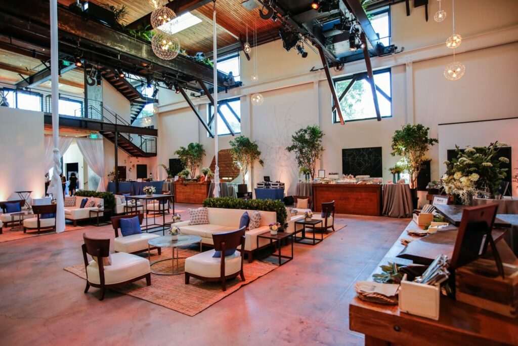 High ceilings with lots of light and multiple lounge set ups at The Pearl venue in San Francisco
