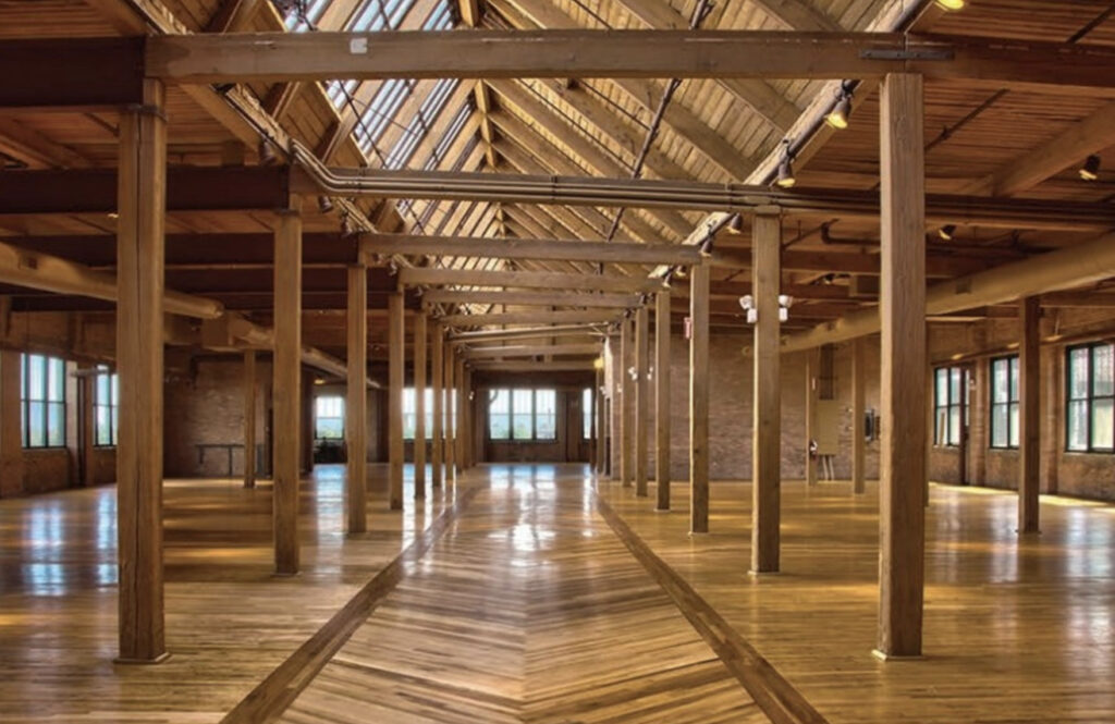 Skyline Loft with wooden floors and exposed wooden beams and a skylight