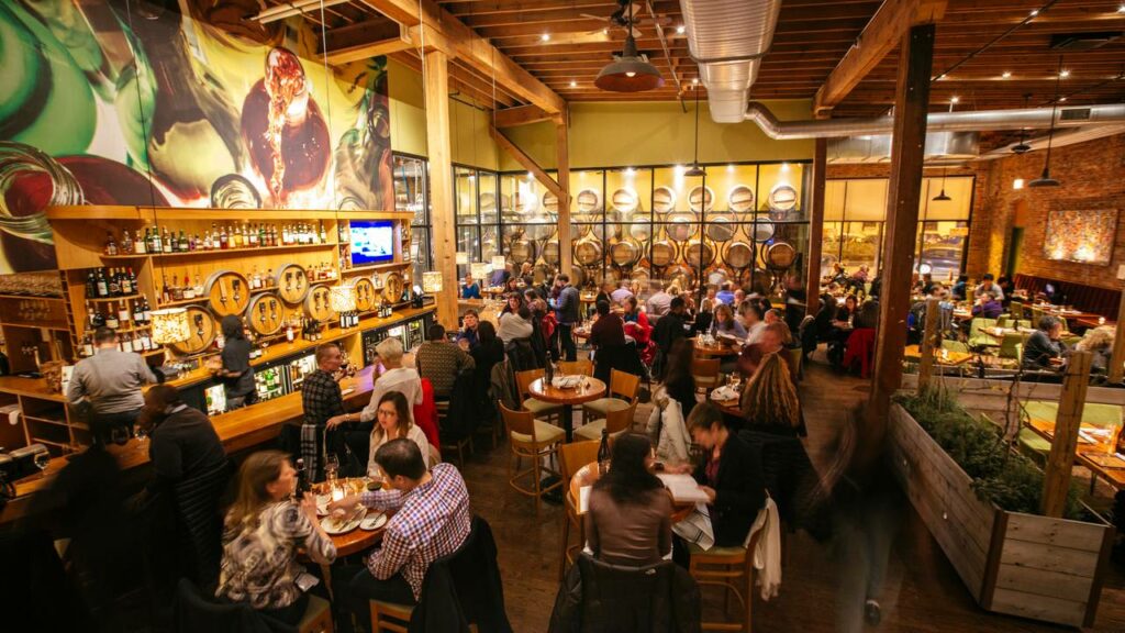 City Winery in Chicago, a packed bar and restaurant with high ceilings and exposed wooden beams