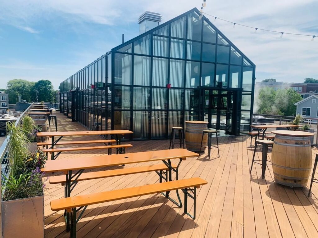 Dorchester Brewing Company roof with a greenhouse build out and picnic tables