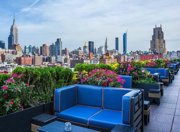 PH-D Rooftop Lounge with blue lounge sets and sweeping views of the New York City skyline