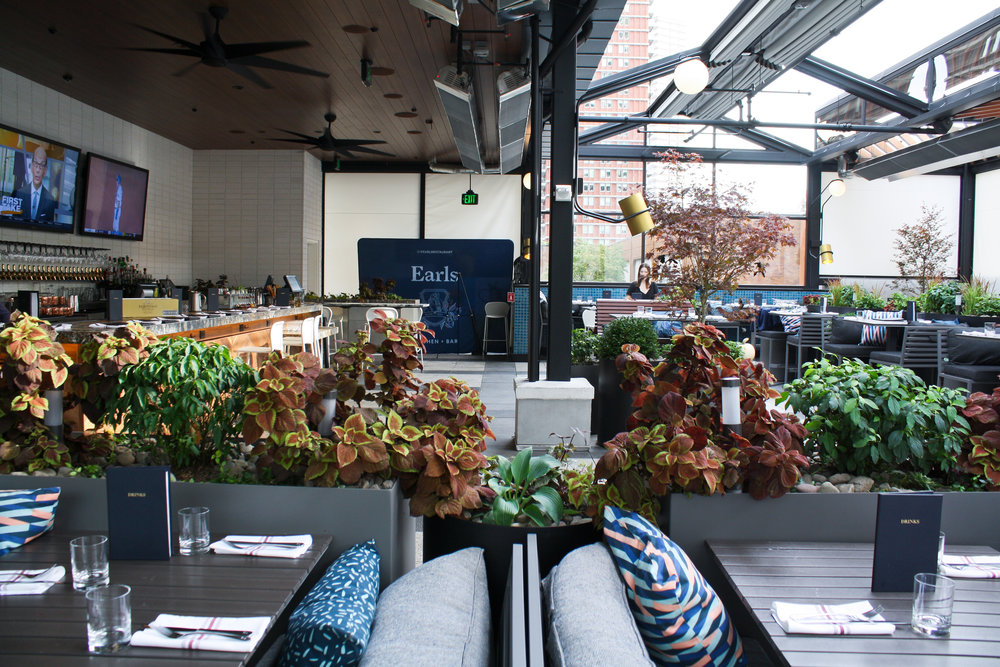 Earls rooftop in Boston with potten plants and retractable roof