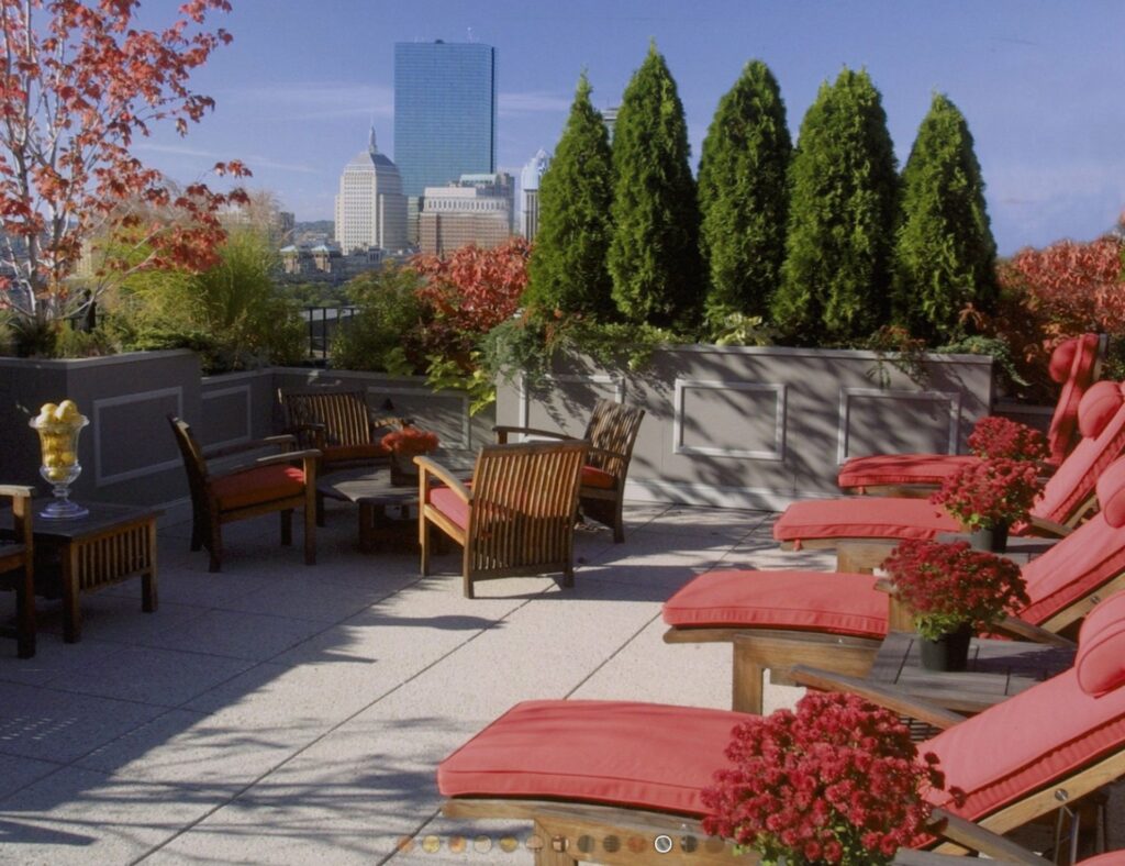 Mooo Restaurant rooftop in Boston with red cushioned lounge chairs