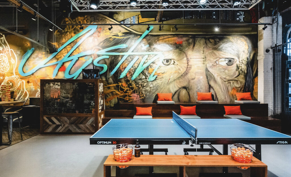 Smash ATX with a large ping pong table and wall murals