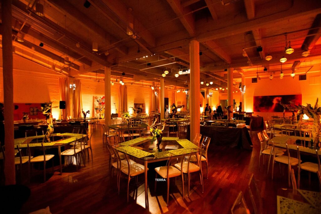 Terra Gallery San Francisco large event space with reddish dim lighting and dining tables