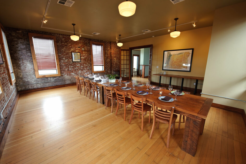 Private dining room with wooden table and brick walls
