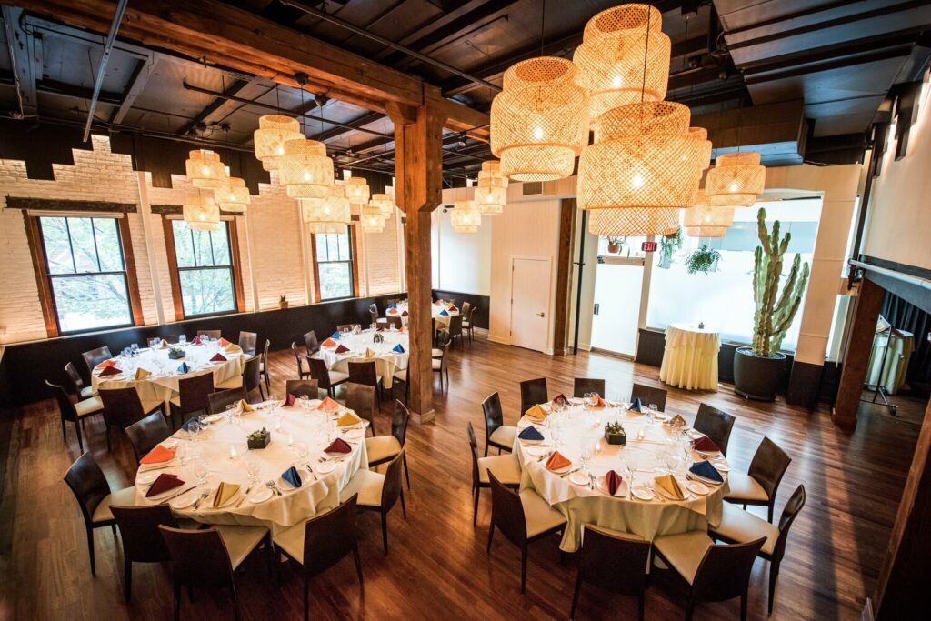 private dining room with white table cloths and chandeliers