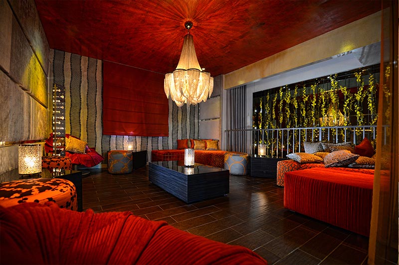 Barton G. The Restaurant in Miami with a red ceiling and red accent furniture