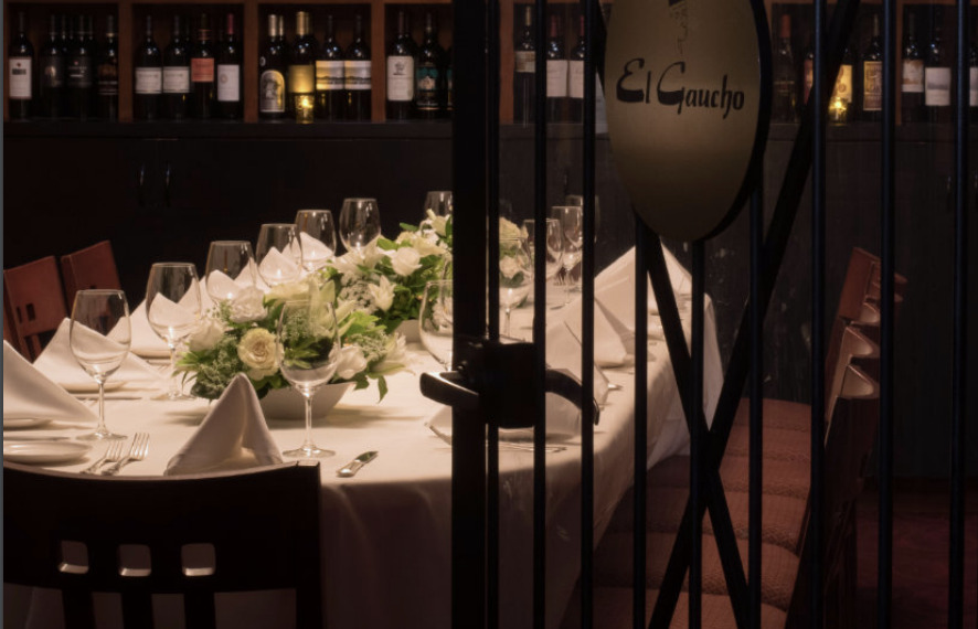 private dining room with white table cloths and flower arrangements