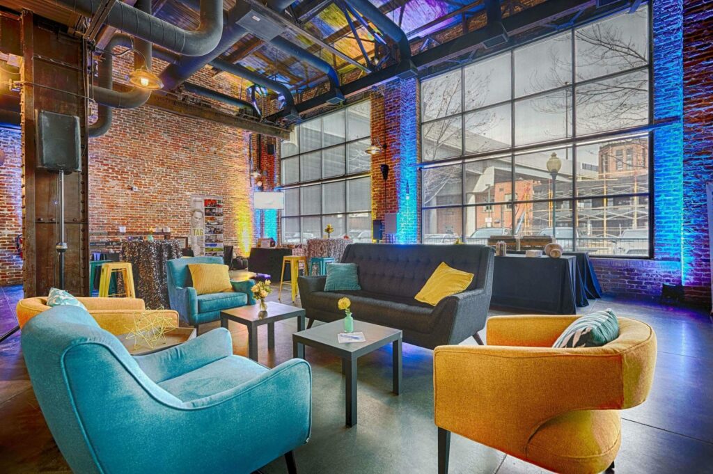 Mile High Station Denver event venue with yellow and blue couches, brick walls, and large windows