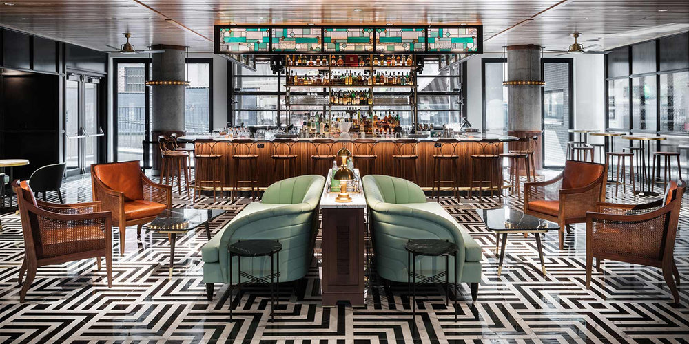 Poka Lola Social club venue with bar and lounge chairs and black and white abstract tiling 