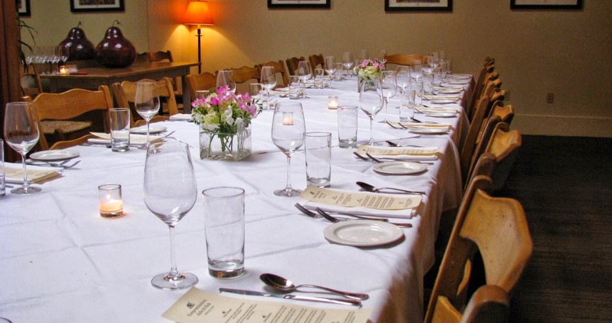 Private dining room table with white table cloth at Serratto in Portland. 