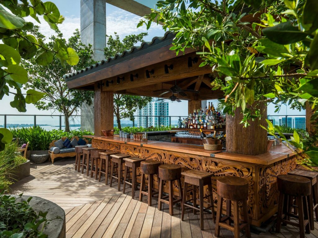 Sugar bar in Miami with a wooden rooftop bar and lots of plant vegetation