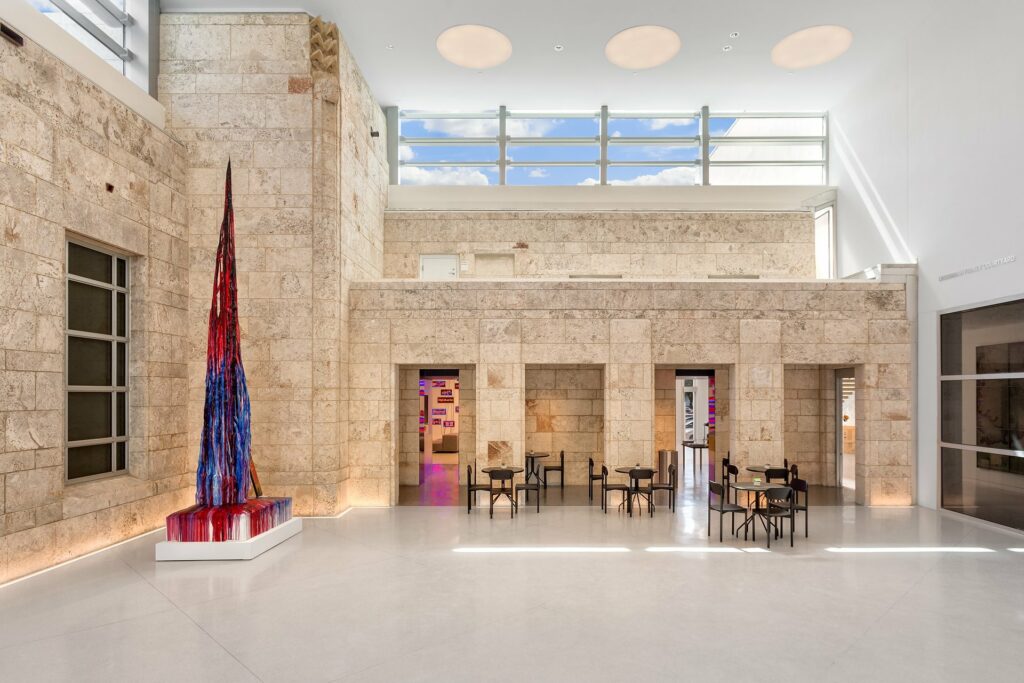 The Bass Museum of Art with a marble floor and stone walls.