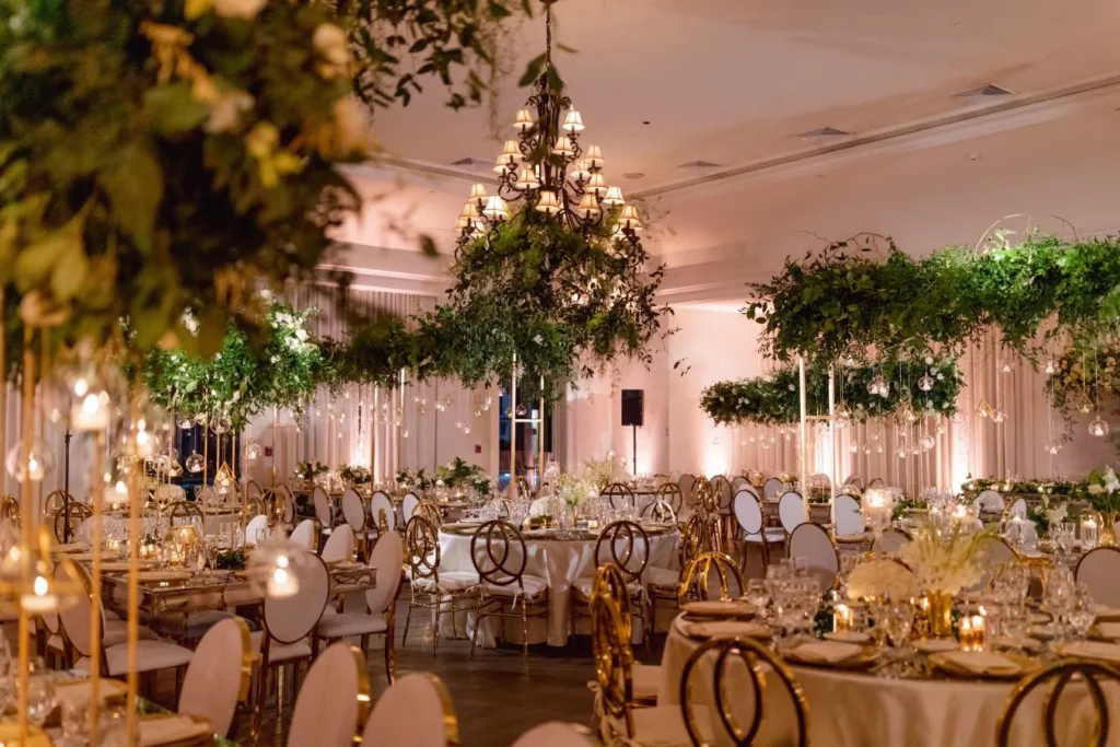 The Bath Club in Miami set up for a large event with tables, chairs. and hanging greenery installations