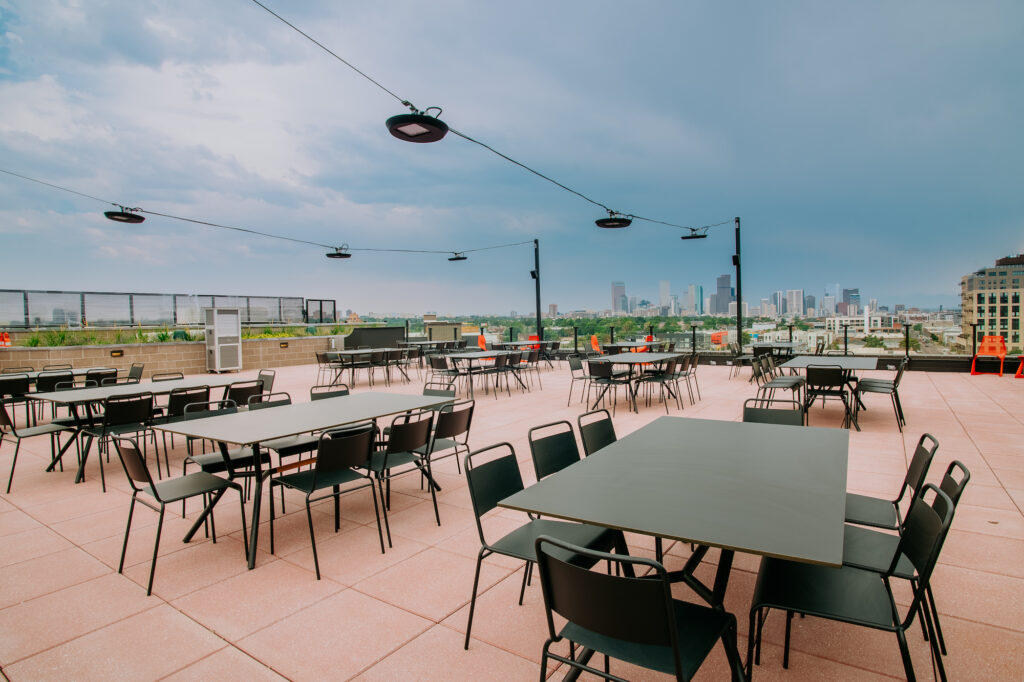 The Red Barber Denver rooftop with city skyline view