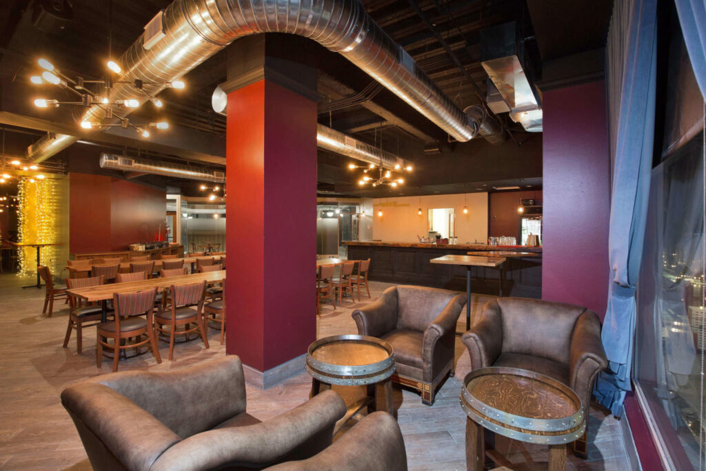 Wright Room Denver event venue witj lounge chairs and barrel tables