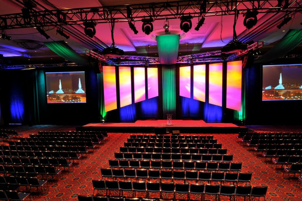 Large convention center with red carpet, stage and projectors