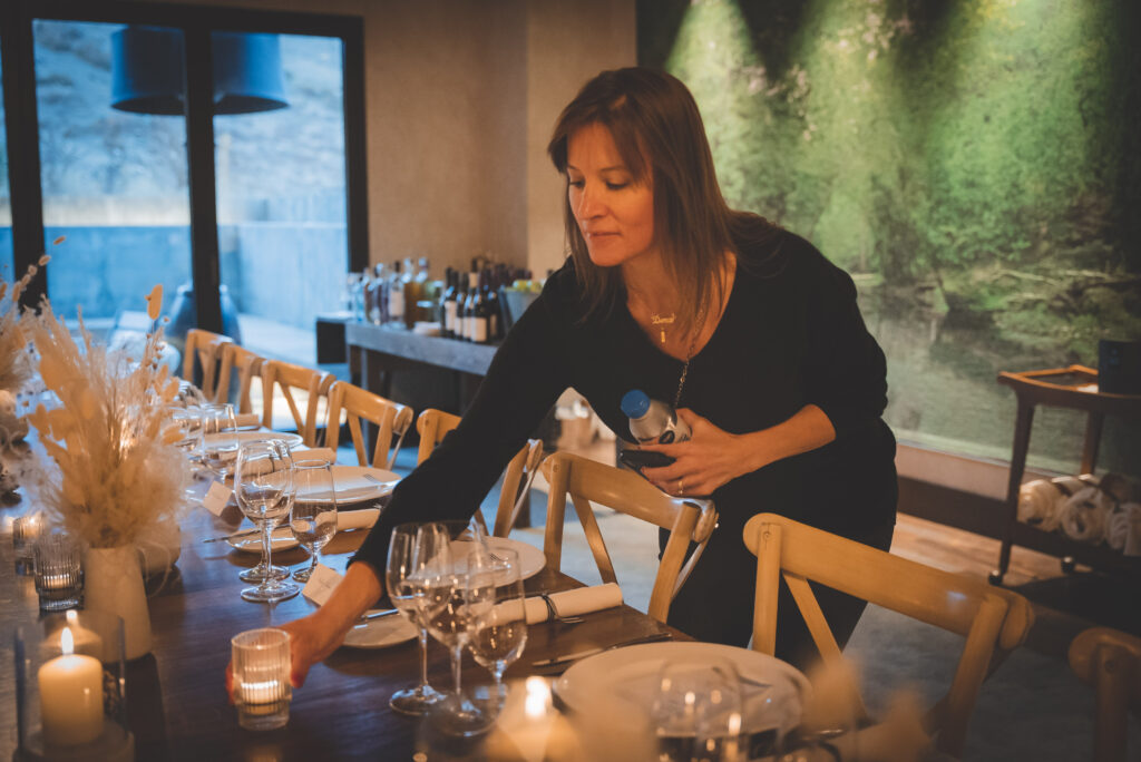 Dera Lee setting candles at a dining table