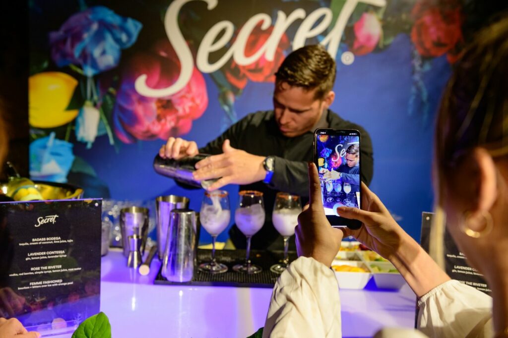 A mixologist making a drink at a 'Secret' event