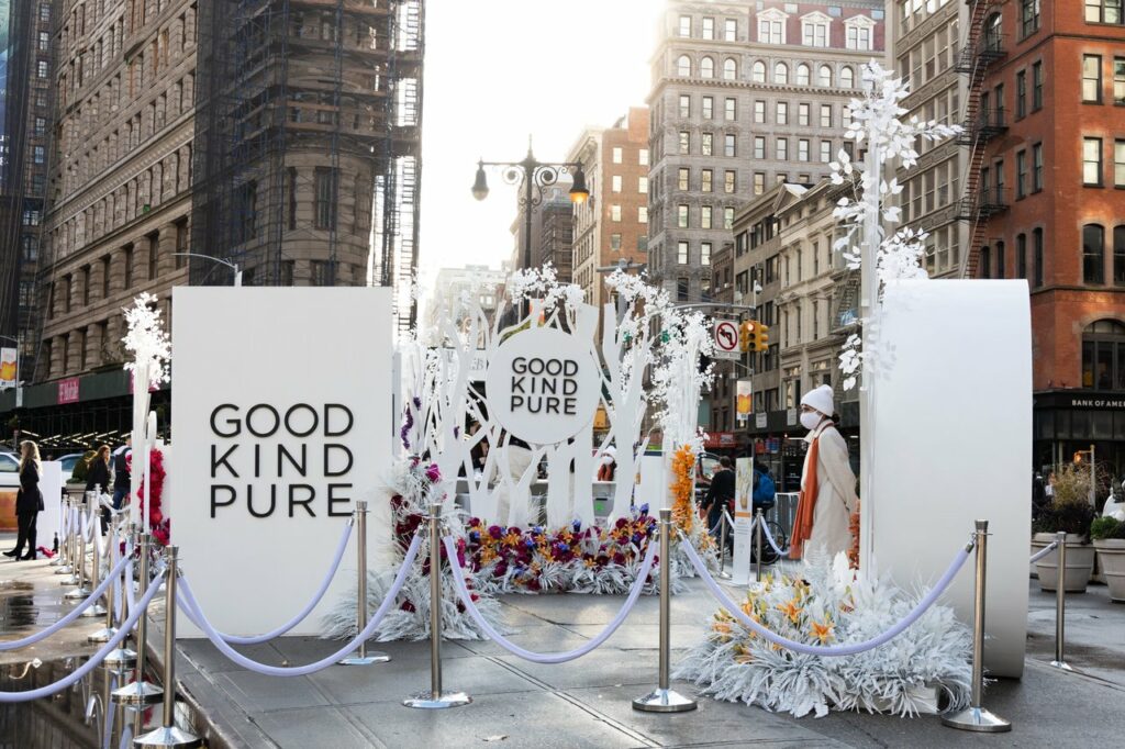 Large white standing signs with 'Good Kind Pure' printed on them outside on a New York street
