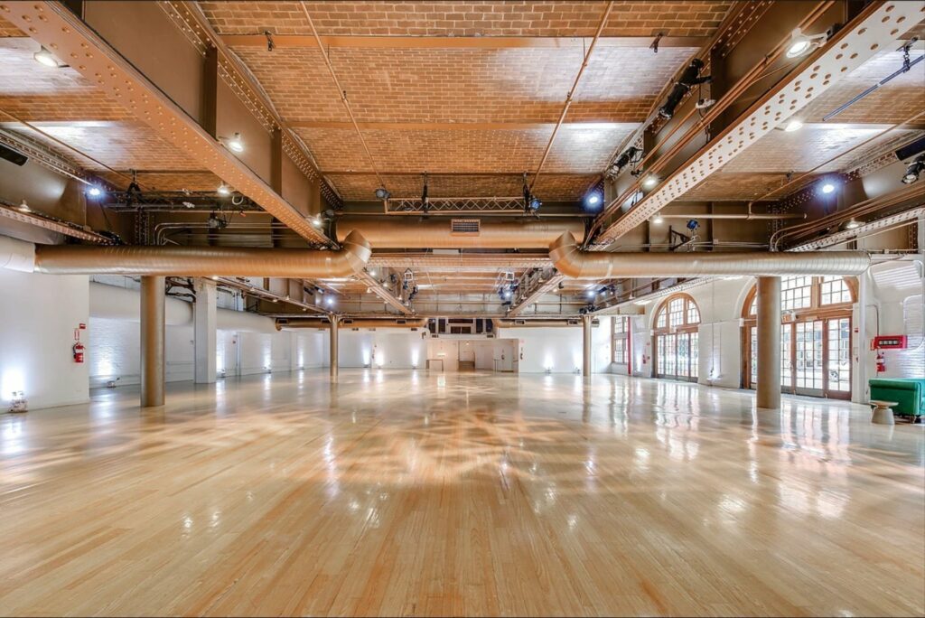 Large event space with wooden floors and brick ceilings 