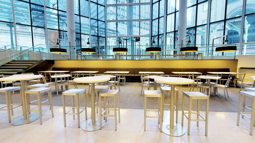 Tables and chairs in a large open lobby