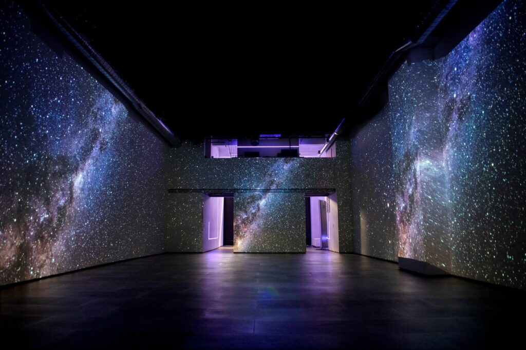 Event space with black floors and walls with an outerspace print