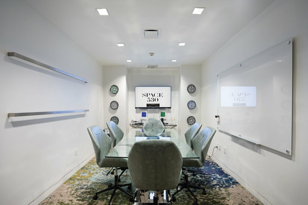 Small meeting space with a six person conference room table