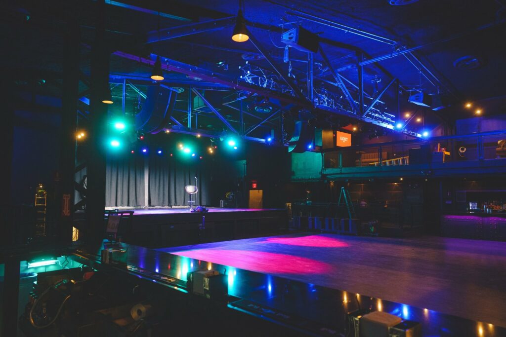 Venue space with a stage setup and colorful lighting