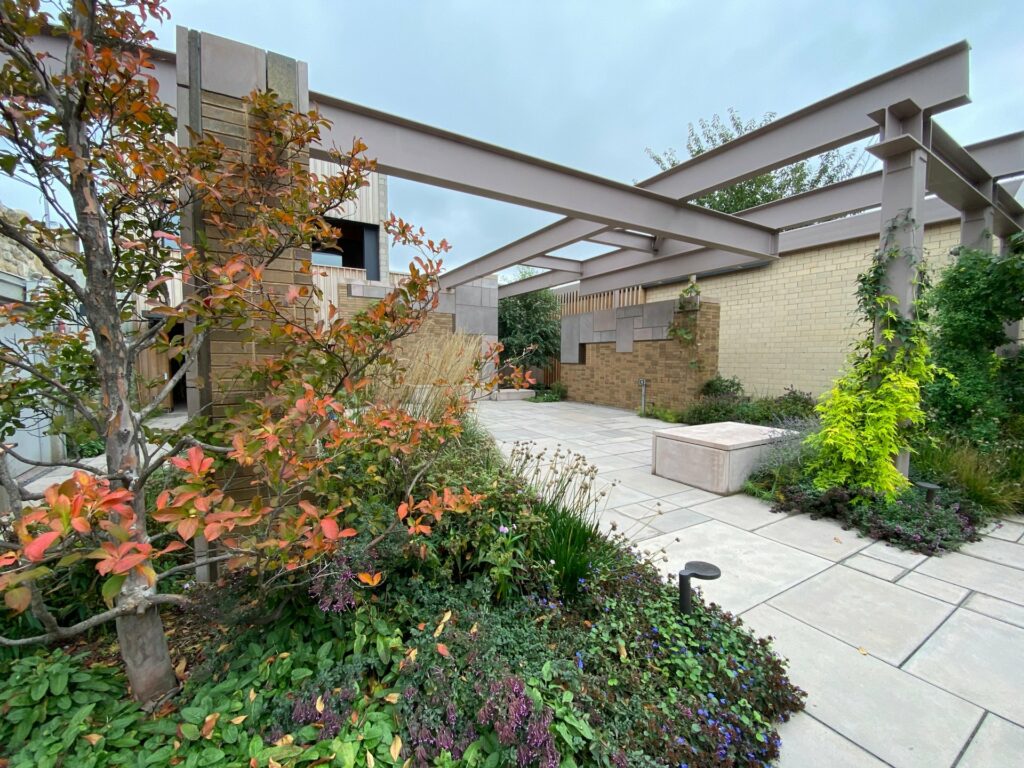 Outdoor venue space with metal beams and lush foliage