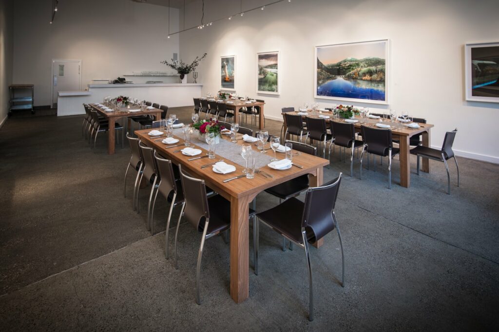 Set dining tables in an art gallery