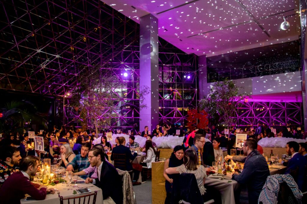 180 Maiden Lane in NYC filled with tables of people at a large event