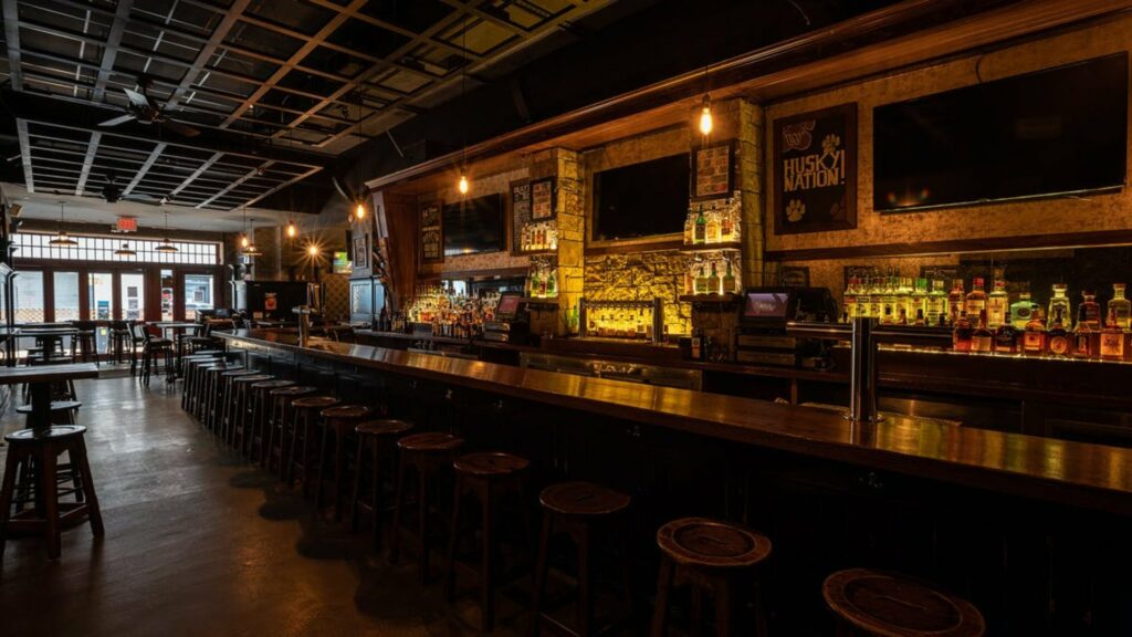 Féile bar in NYC with low lighting and a long wooden bar