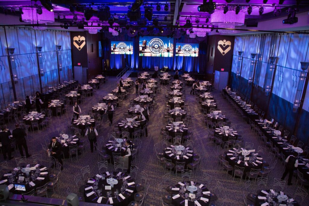 Round banquet tables with blue and purple lighting in large space