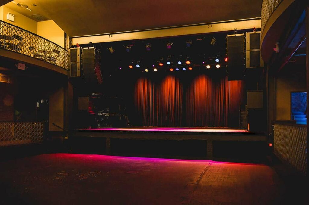 Stage with red curtains and large floor space