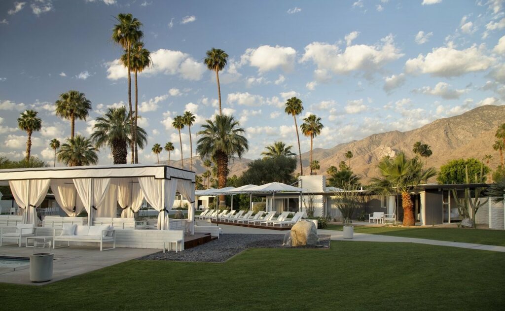 A resort with palm trees a gazebo at a Coachella event venue
