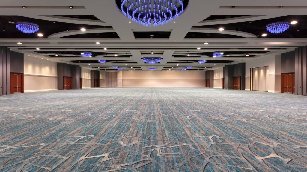 Orlando World Center Marriott ballroom event space with green and grey carpet and blue chandelier lighting 