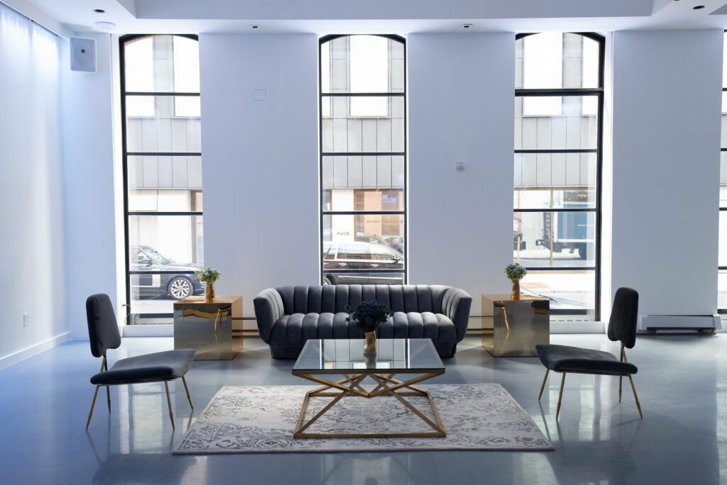 Lounge furniture under large windows at street level