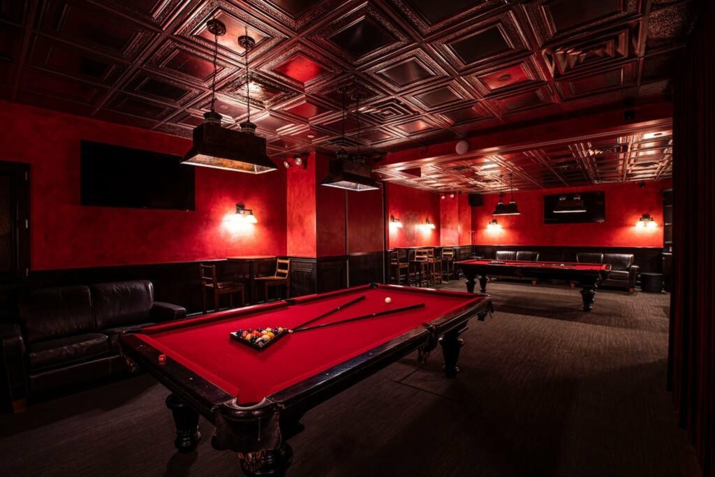 Red pool table room with red walls and lighting