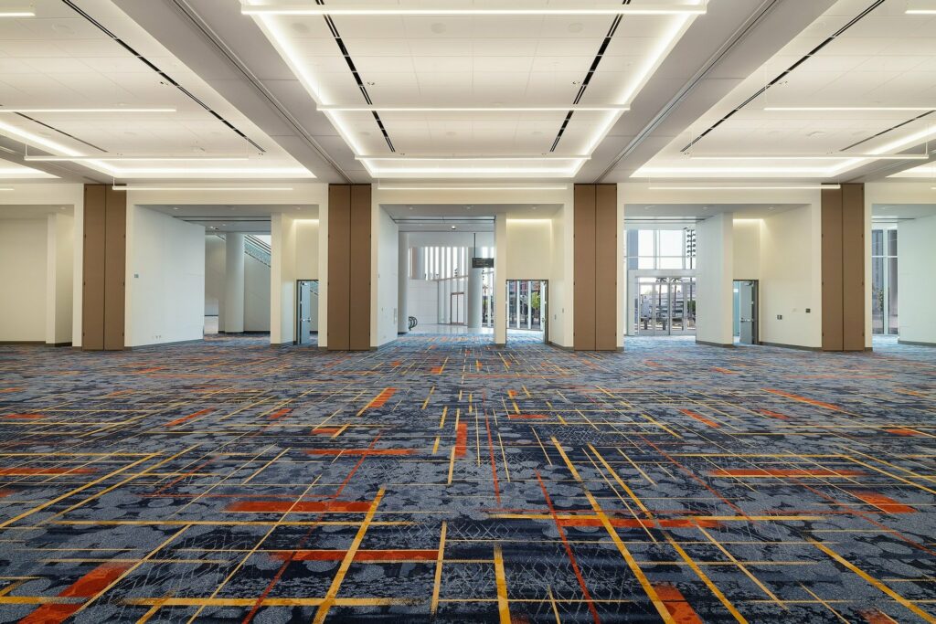 A spacious empty ballroom with multiple division pillars
