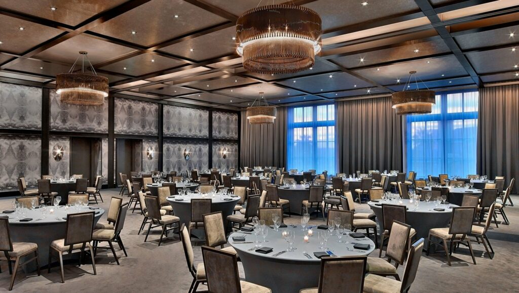 An elegant spacious indoor venue with high ceiling and floor-to-ceiling windows. 