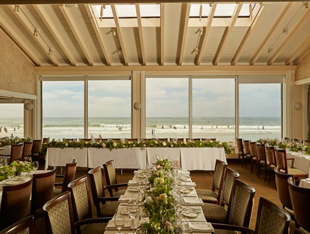A private dining room with large windows and an overlooking views of the ocean