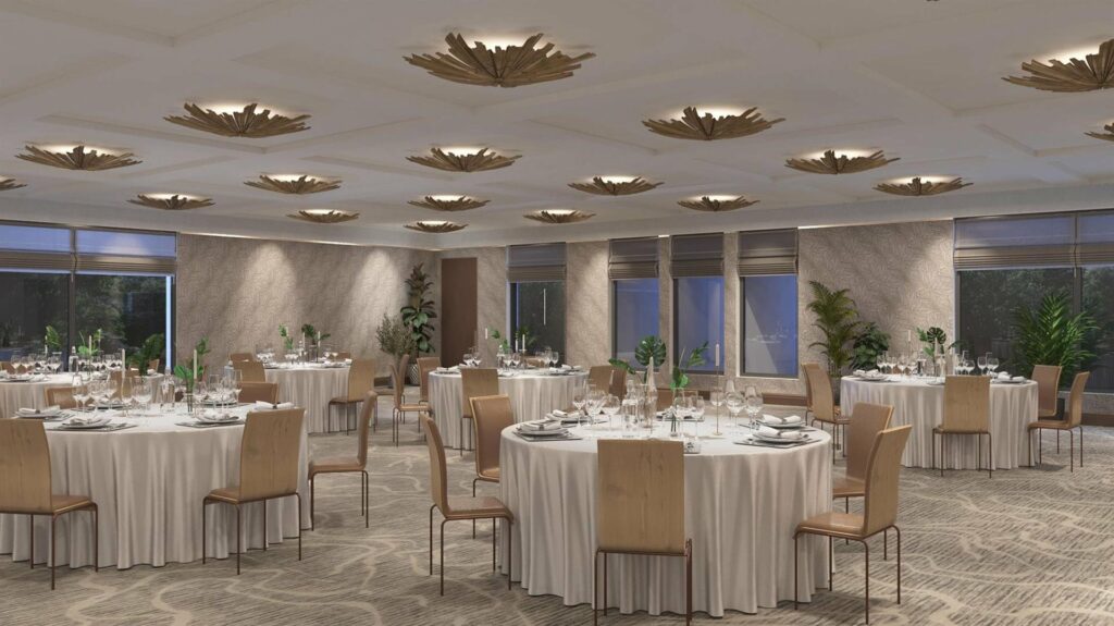 A ballroom that features beautiful modern decor, plenty of natural light, and views of the lush gardens.