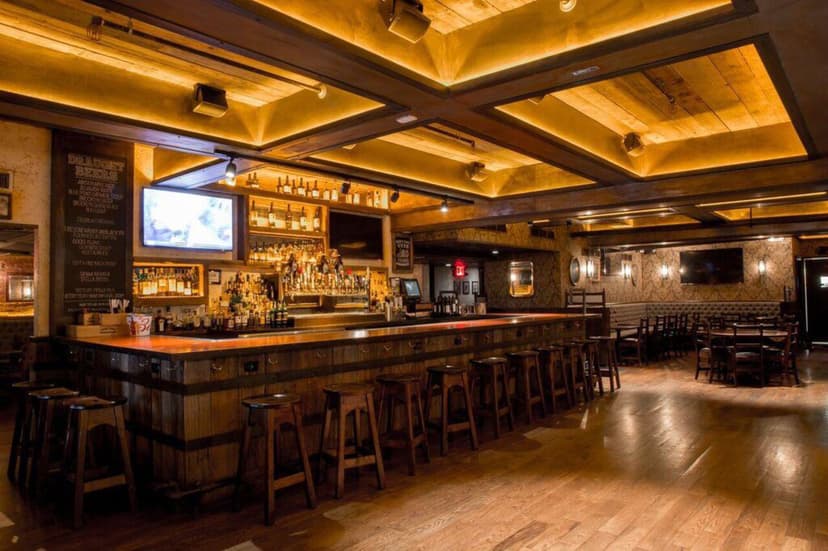Stout Grand Central bar with a large wooden bar and wooden bar stools